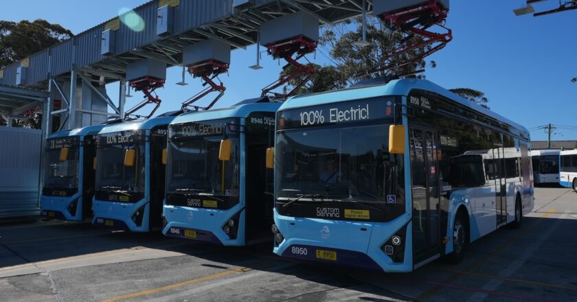Electric buses charging at Sydney’s Brookvale depot using gantry-mounted fast chargers, marking its conversion to the city’s first all-electric bus hub.