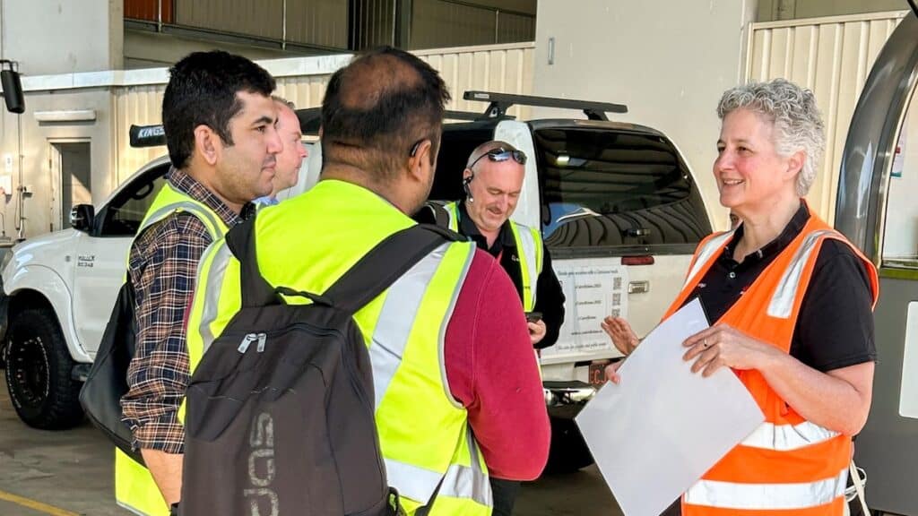 Busways safety manager speaks with depot staff during a workplace safety review, highlighting team engagement and feedback in improving bus depot safety systems.