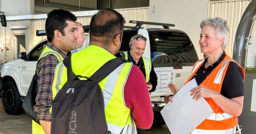 Busways safety manager speaks with depot staff during a workplace safety review, highlighting team engagement and feedback in improving bus depot safety systems.